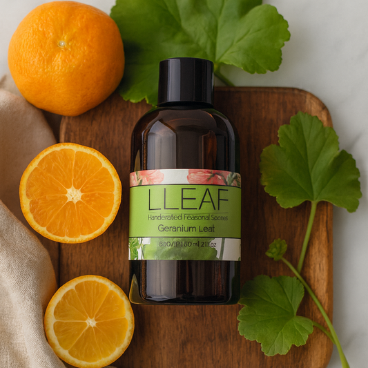 Bottle of LLEAF product on a wooden board with oranges and leaves on a light background