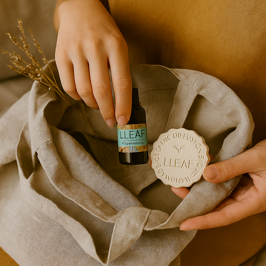 Person holding a bottle labeled 'Lleaf' and a cloth with the same label on a neutral background