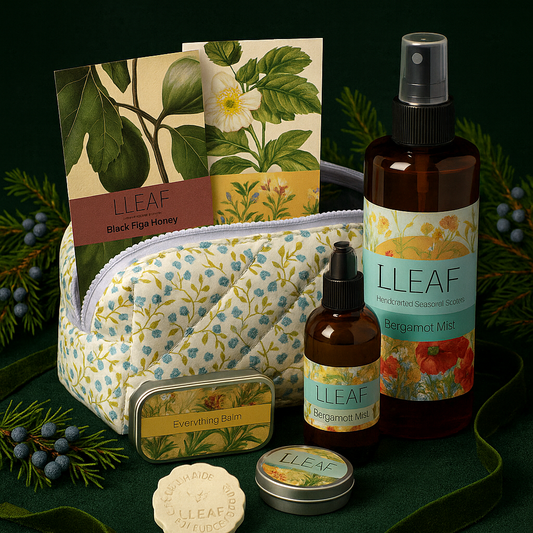 Collection of LLEAF products including a pouch, bottles, and a card on a green background with foliage.