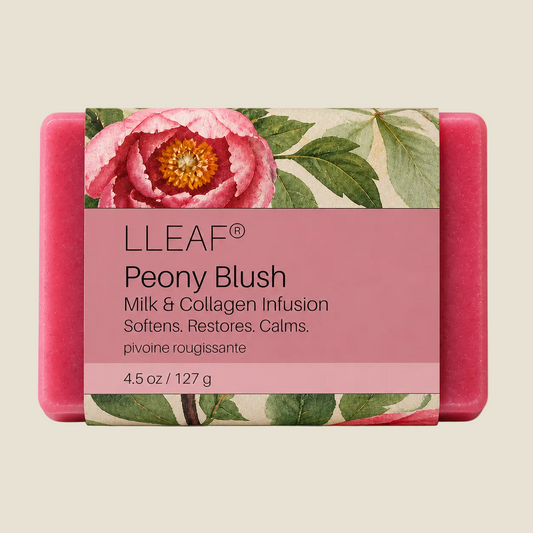 A rectangular pink LLEAF Peony Blush soap bar with a floral paper label featuring a large pink peony and green leaves, shown on a light beige background.