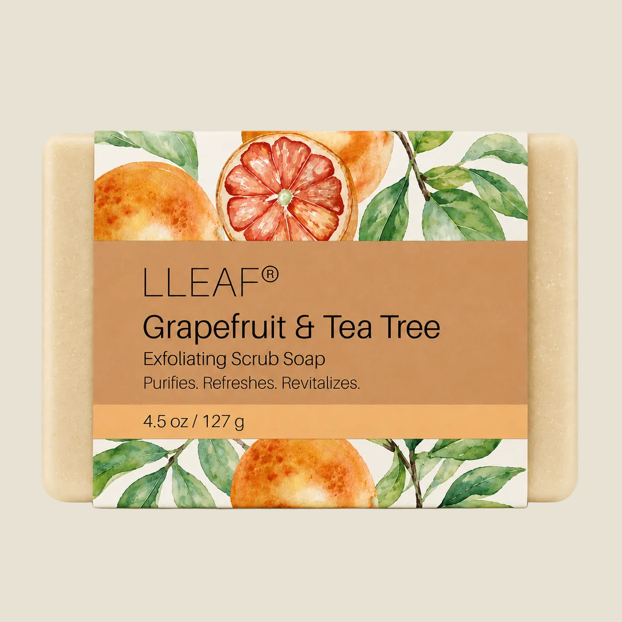 A rectangular bar of LLEAF Grapefruit & Tea Tree exfoliating scrub soap with a tan paper label, set against a solid light beige background. The soap bar itself is a natural, warm beige color, and the label features watercolor illustrations of grapefruit and green tea tree leaves.