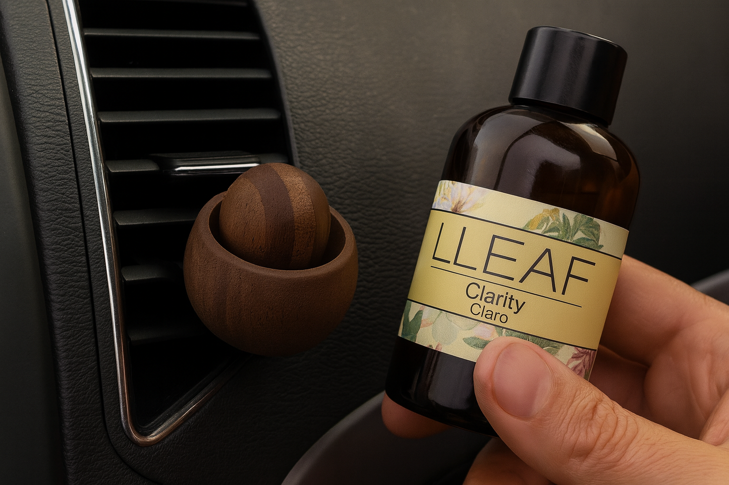 Bottle of LLEAF Clarity oil held in front of a car air vent.