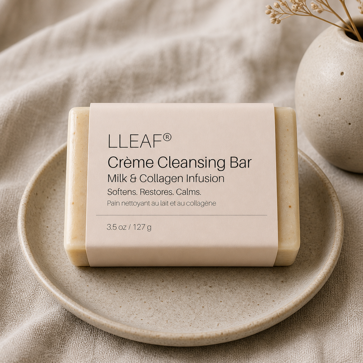Creme Cleansing Bar by LLEAF on a plate with a neutral background